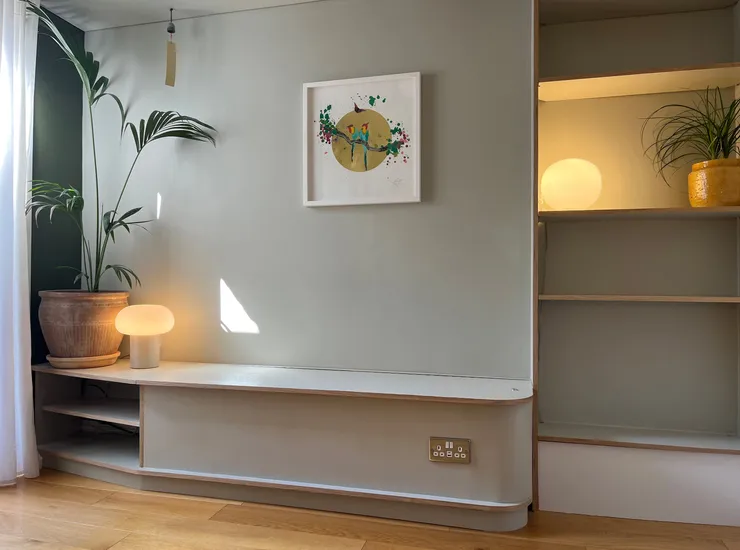 Living room with green banquet seating and adjustable shelving